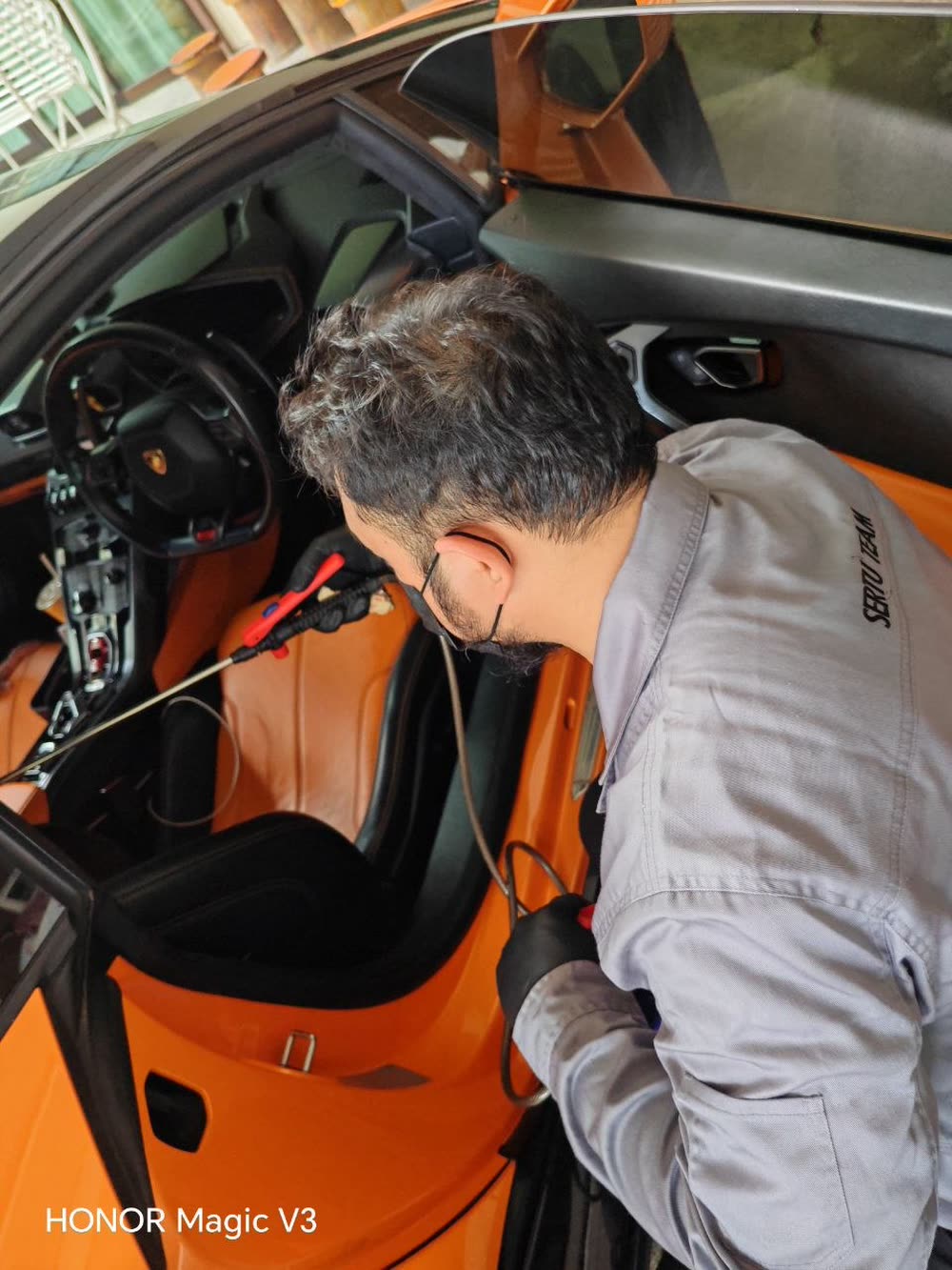 SafaaClean technician performing Sertu steam cleaning on a Lamborghini interior